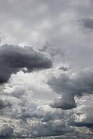 Towering dark and pale gray clouds fill the sky in a dramatic, densely layered cloudscape [IBR125657399]