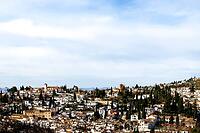 The roofs and houses of Granada stretch over a rolling hill under a bright sky, view from the Alhambra, Alhambra, Granada, Province of Granada, Andalusia, Spain [IBR125657420]