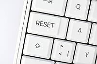 Reset button on white keyboard representing AI overload and digital reset [IBR125659518]