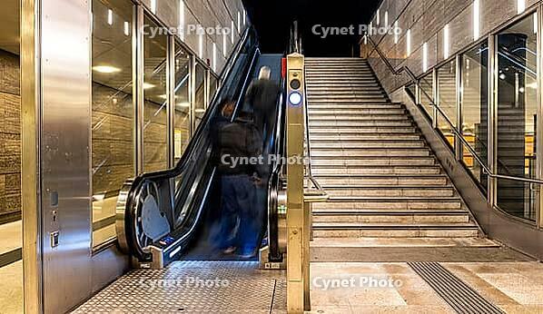 Night photo, long exposure with motion blur, modern underground entrance at Unter den Linden station, contemporary design with stairs and escalator, Berlin, Germany [IBR112672577]