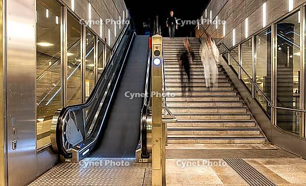 Night photo, long exposure with motion blur, modern underground entrance at Unter den Linden station, contemporary design with stairs and escalator, Berlin, Germany [IBR112672585]