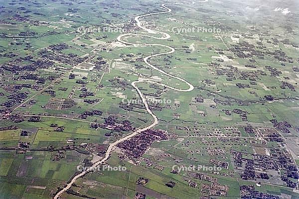 Captioned as 'aerial photo Saigon', meandering river in flat agricultural landscape of paddy fields, Vietnam, south east Asia c 1964 [IBR112672604]
