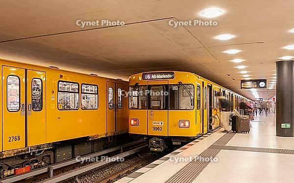 Dynamic scene of a Berlin underground in typical yellow colour, long exposure with blur effect, busy traffic junction at Unter den Linden station, Berlin, Germany [IBR112672611]