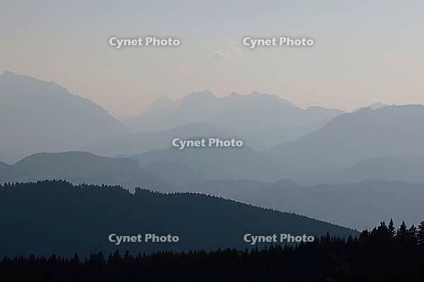 View from Austria to the Berchtesgaden Alps with Hohem Göll, Watzmann, Hochkalter and Untersberg in hazy evening light, Upper Bavaria, Bavaria, Germany [IBR123435194]
