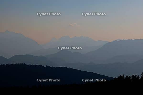 View from Austria to the Berchtesgaden Alps with Hohem Göll, Watzmann, Hochkalter and Untersberg in hazy evening light, Upper Bavaria, Bavaria, Germany [IBR123435195]