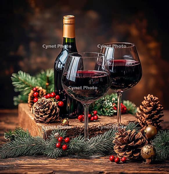 Two glasses of red wine stand on a table surrounded by fir branches and cones, AI generated [IBR123435200]