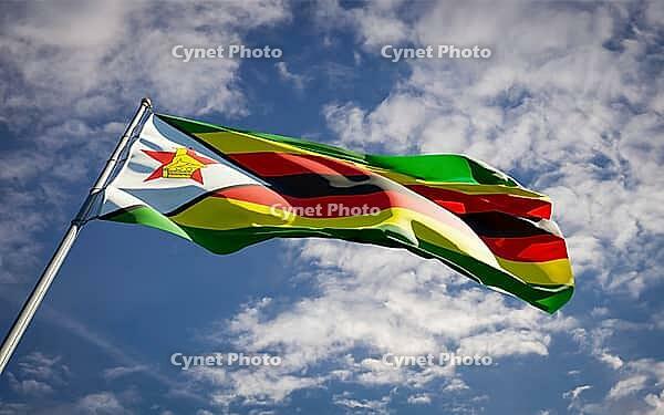 Beautiful national state flag of Zimbabwe fluttering at sky background. Low angle close-up Zimbabwe flag 3D artwork [IBR123569286]