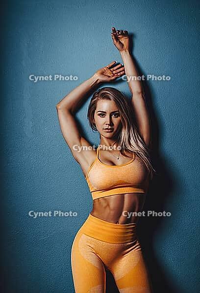 Young sexy fitness woman portrait on wall background [IBR123569352]