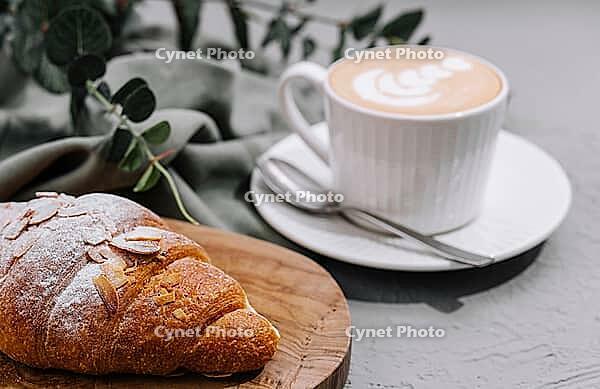 Food, Almond Croissant on plate with cup of coffee [IBR123622482]