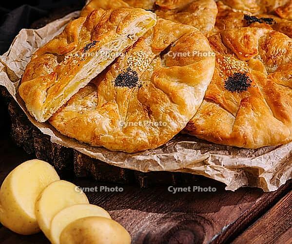 Food, Cooking traditional pies with potato on wooden board [IBR123622500]