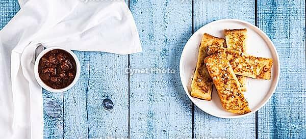 Golden sweet croutons of bread on a plate on the table top view web banner [IBR123629707]