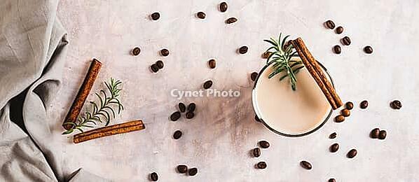 Cup of iced latte with rosemary and cinnamon on the table top view web banner [IBR123629710]