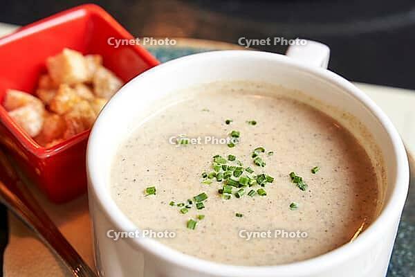 Creamy onion soup with green. Health food at cafe. Classic cuisine. Cooking bowl with bread croutons. Yam dish. Hot vegetable plate [IBR123629781]
