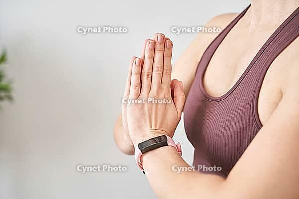 Young woman going yoga exercise at home. Relax meditation. Health care online lessons. Indoor fitness workout. Remote sport trainer. Morning activity. Floor pilates mat. Female person lifestyle. Asana [IBR123638346]