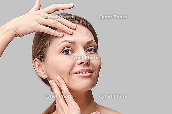 Pure skin care mature beauty portrait. Cosmetology plastic foundation. Anti wrinkle senior cream. Elegant Hands near female head. Medical treatment clinic. Woman nature makeup [IBR123638349]