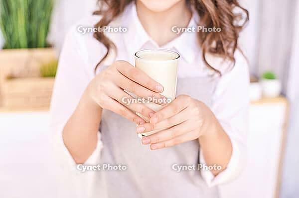 Young girl cooking at kitchen with vegetables. pretty child portrait. Chef student. Attractive brunette. Children emotion. People baking in cook apron. Close recipe menu [IBR123638366]