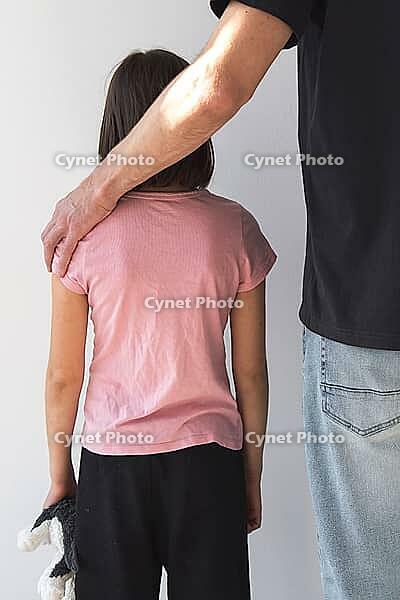 Vertical photo, child girl and man from behind, adult man's hand on child's shoulder, concept of child abuse, kidnapping and violence against children [IBR123638385]
