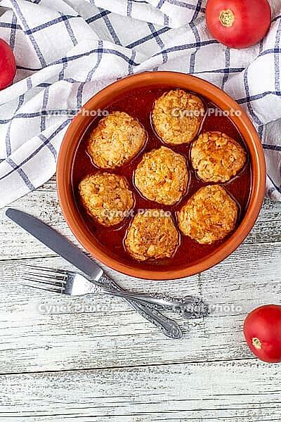 Meatballs in tomato sauce in a bowl on wooden table. Tasty dinner food. Top view copy space [IBR123639575]