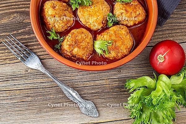 Meatballs in tomato sauce in a bowl on wooden table. Tasty dinner food. Top view [IBR123639578]