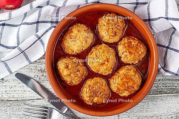 Meatballs in tomato sauce in a bowl on wooden table. Tasty dinner food. Top view [IBR123639581]