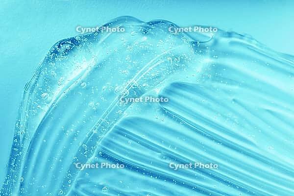 Gel texture. Blue gel sanitizer swatch. Antibacterial hygiene sanitiser splash. Skincare hydration product with aloe vera and collagen. Liquid clear jelly smear. Serum, shampoo or shaving cream smudge [IBR123646462]