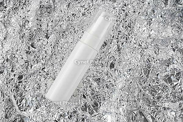 Beauty treatment skincare and cosmetic lotion cream mockup bottle packaging product flat lay. Mock up white spray for moisturizer, facial cleanser, shampoo on silver crumpled metal texture top view [IBR123646464]