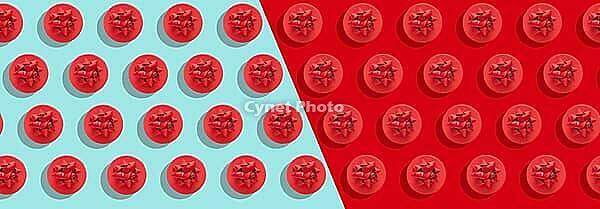 Pattern red gift box with decorative bow on blue and red surface top view flat lay. Holiday concept new year or Christmas gift box presents Xmas holiday, long banner [IBR123646470]