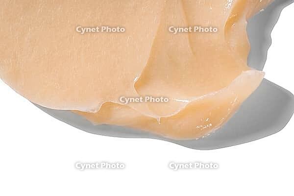 Hair conditioner cream swatch smear on white background. Yellow cosmetic lotion moisturiser sample closeup. Body care balm, retinol serum, shampoo wavy texture. Skincare mask, creamy cleanser product [IBR123646501]