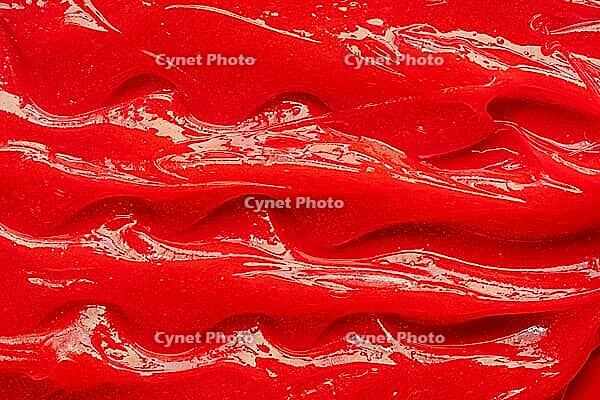 Red gel texture. Cosmetic clear liquid cream smudge. Skin care product sample closeup. Toothpaste or wax background [IBR123646504]