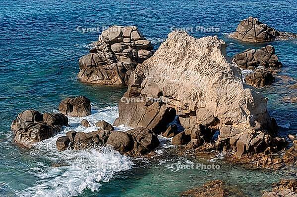 Waves on rocky beach, sea shore with waves crushing over the big rocks, summer sunny day [IBR123646505]