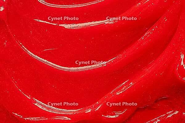 Red gel texture. Cosmetic clear liquid cream smudge. Skin care product sample closeup. Toothpaste or wax background [IBR123646506]