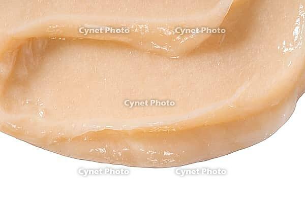 Hair conditioner cream swatch smear on white background. Yellow cosmetic lotion moisturiser sample closeup. Body care balm, retinol serum, shampoo wavy texture. Skincare mask, creamy cleanser product [IBR123646507]