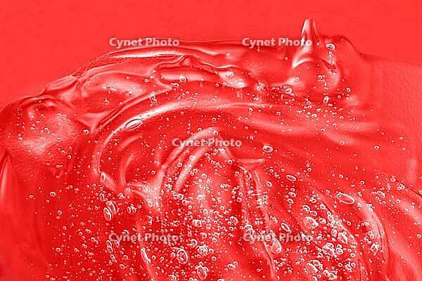 Hyaluronic acid toner swatch. Transparent cream sample smudge with collagen and vitamin. Serum liquid cosmetics, jelly cosmetic product. Red moisturizer smear. Gel texture with bubbles. Closeup, macro [IBR123646516]