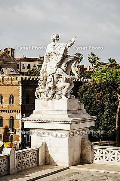 Rome, Italy - 09.12.2022: Historical marble statue near Monument to Victor Emmanuel II in urban setting classical art and architecture [IBR123646520]
