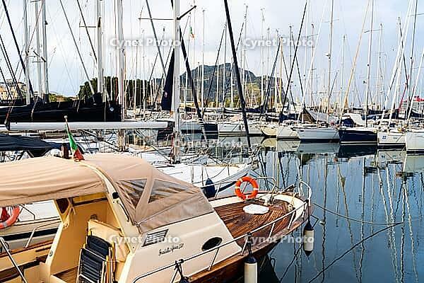 Castellammare del Golfo, Italy - 05.11.2022: Scenic marina with sailing boats and yachts docked in front of scenic mountainous backdrop [IBR123646528]
