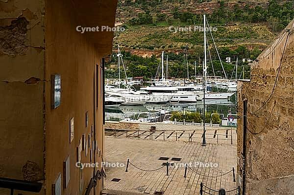 Castellammare del Golfo, Italy - 05.11.2022: Picturesque harbor view with yachts docked at quaint coastal village [IBR123646538]
