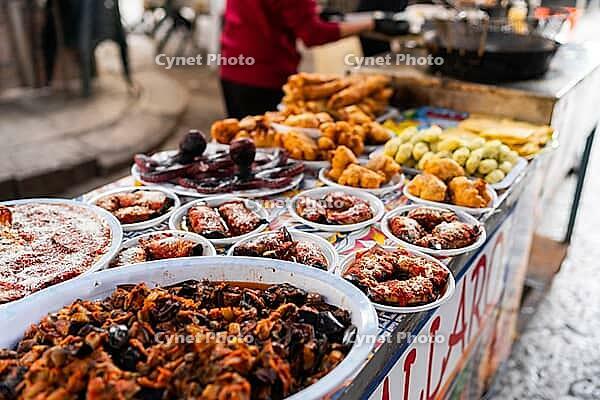 Palermo, Italy - 06.11.2022: Vibrant mexican street food market with assorted traditional dishes displayed on vendor stall [IBR123646541]