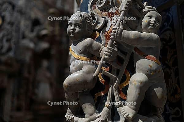 Monreale, Italy - 04.11.2022: Baroque cherub sculptures with musical instrument in ornate architectural setting [IBR123646542]