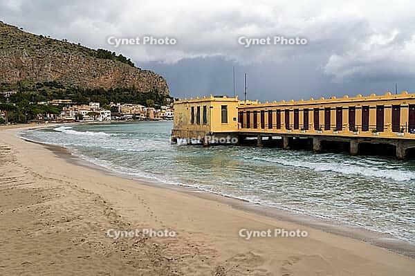 Castellammare del Golfo, Italy - 05.11.2022: Scenic coastal view of historic pier and beach in Sicily [IBR123646547]