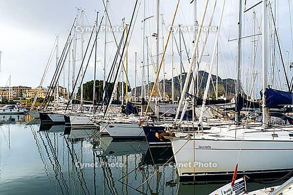 Castellammare del Golfo, Italy - 05.11.2022: Sailing boats docked in marina with mountain views for nautical adventure and travel inspiration [IBR123646553]