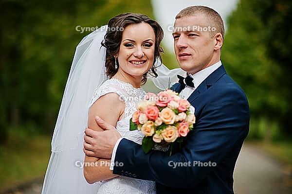 Wedding couple walking at green park [IBR123675070]