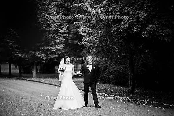 Wedding couple walking at green park [IBR123675100]