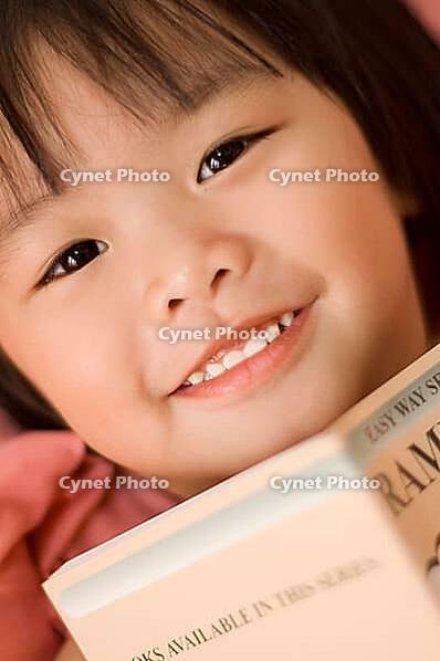 Little girl reading [IBR123713370]