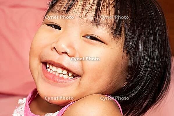 Close-up shot of a young Asian girl with smile on her face [IBR123713373]