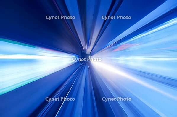 Speedy train moving fast into blue tunnel [IBR123713377]