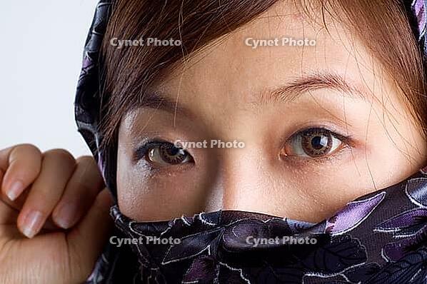 Close-up of a islamic woman covered with veil [IBR123713391]
