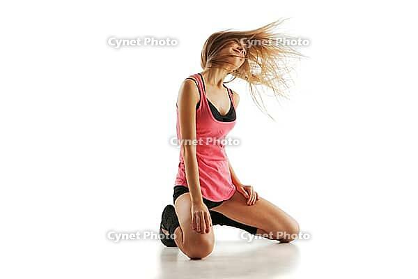 Young beautiful dancer posing on a white studio background [IBR123723156]