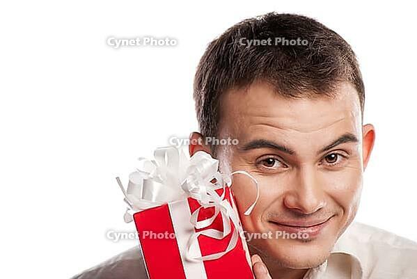 Close-up portrait of smiling man holding gift isolated on white background [IBR123723161]