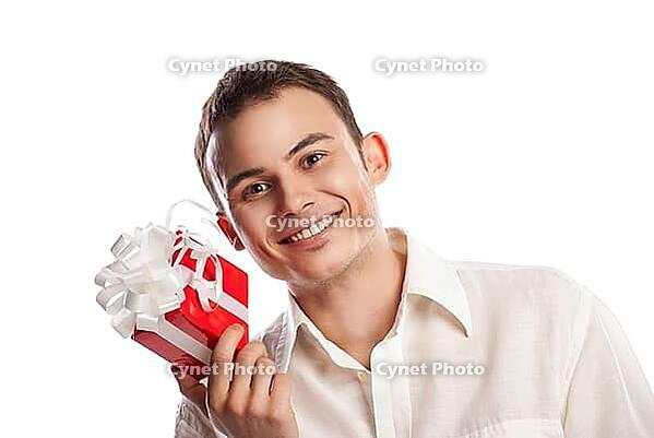 Close-up portrait of smiling man holding gift isolated on white background [IBR123723166]