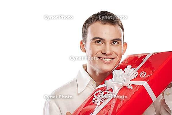 Close-up portrait of smiling man holding gift isolated on white background [IBR123723167]